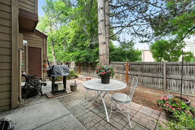 a view of a chairs and tables in the back yard of the house