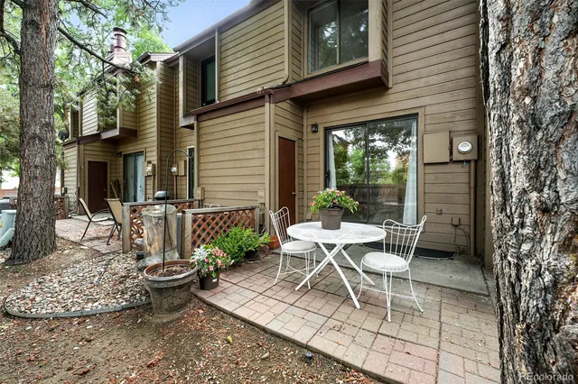a view of a patio with table and chairs and potted plants
