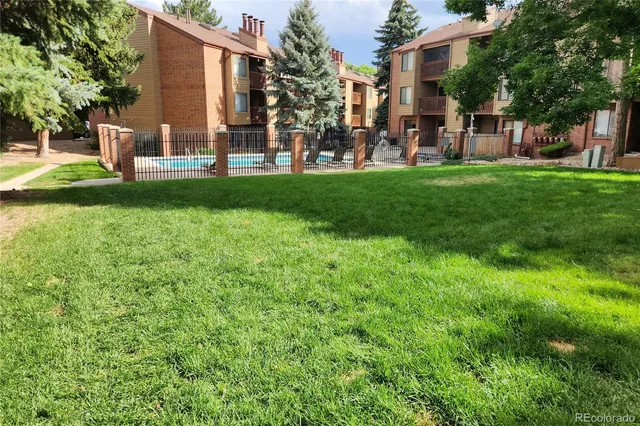 a view of a house with a yard and sitting area