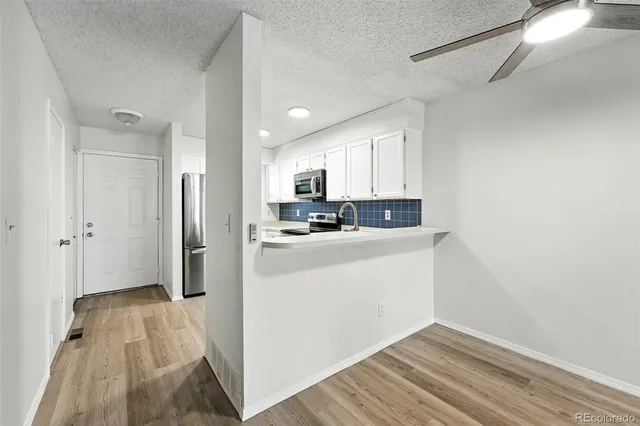 a view of kitchen and wooden floor