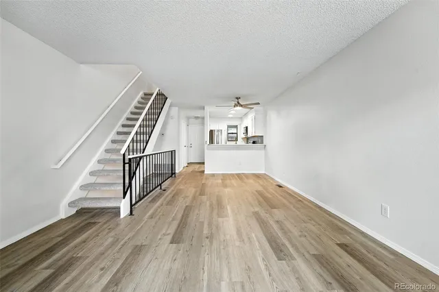 a view of a room with wooden floor and stairs