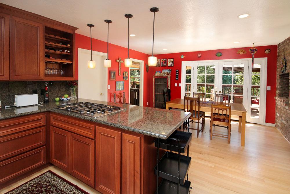 1 Oak Road Santa Cruz, CA 95060 - Photo 11 of 25 a kitchen with stainless steel appliances a stove a sink a dining table and chairs with wooden floor