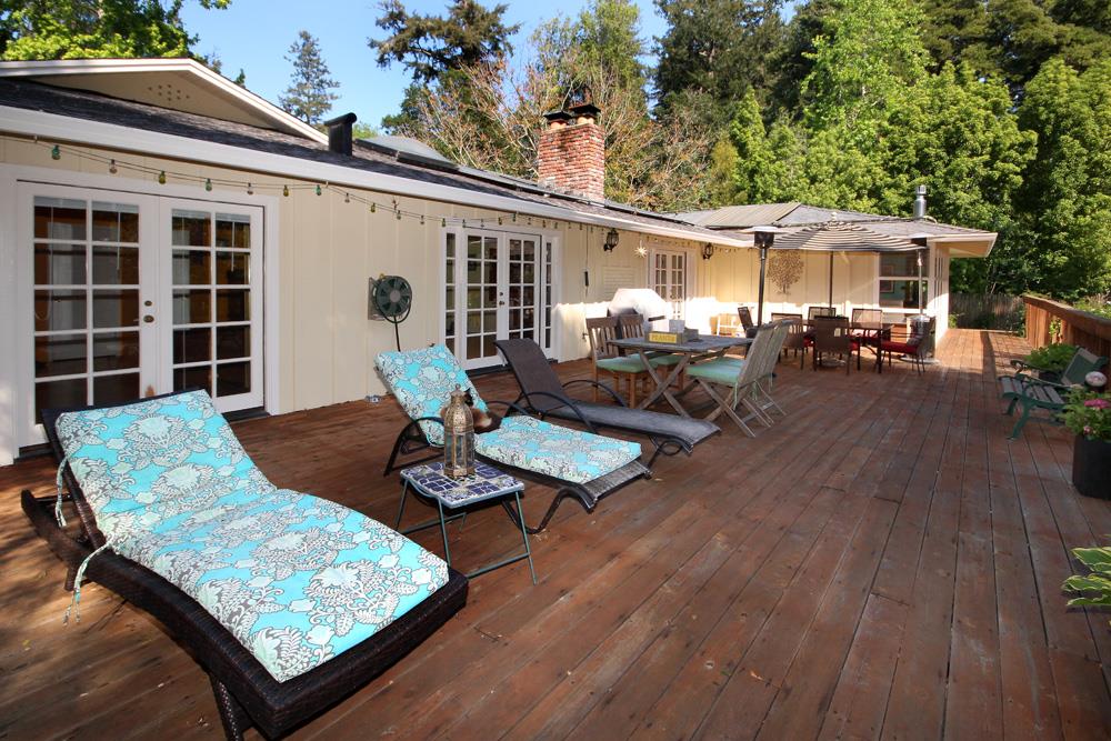 1 Oak Road Santa Cruz, CA 95060 - Photo 3 of 25 a view of a patio with table and chairs with wooden floor and fence