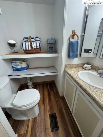 a bathroom with a toilet a sink and mirror
