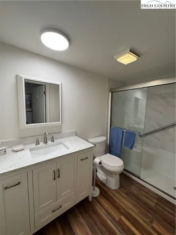 a bathroom with a toilet sink and a mirror