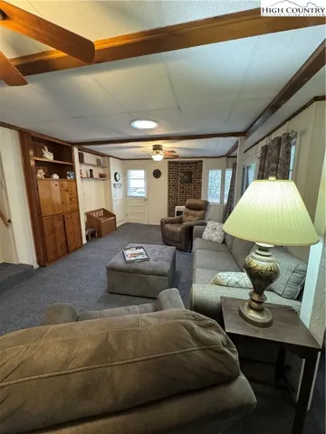 a living room with furniture and a lamp