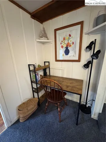 a view of a room with furniture and a window