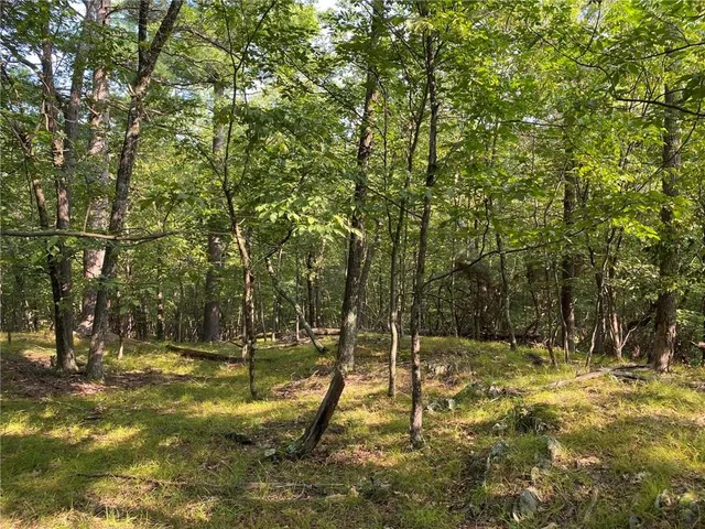 an outdoor sitting area with a lake view
