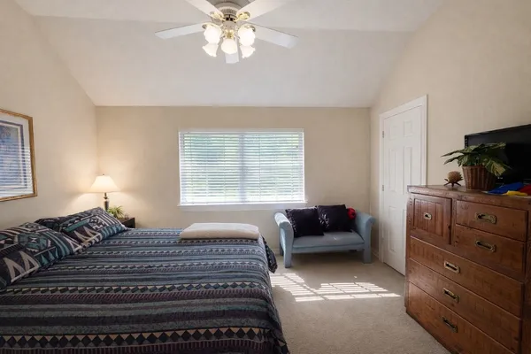 a bathroom with a granite countertop sink toilet a mirror and shower