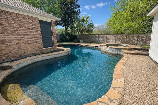 a view of a backyard with swimming pool