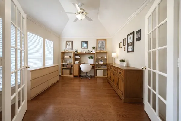 a bedroom with a bed window and a chair