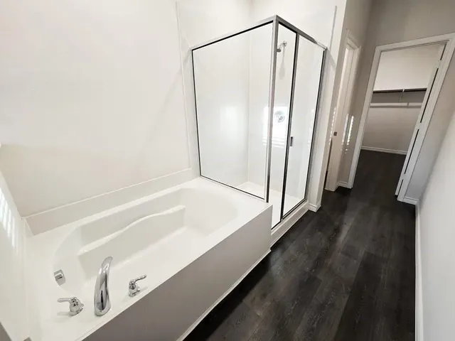 a bathroom with a bathtub and a shower