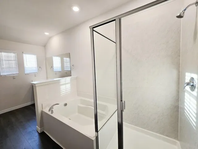 a bathroom with a bathtub and a shower