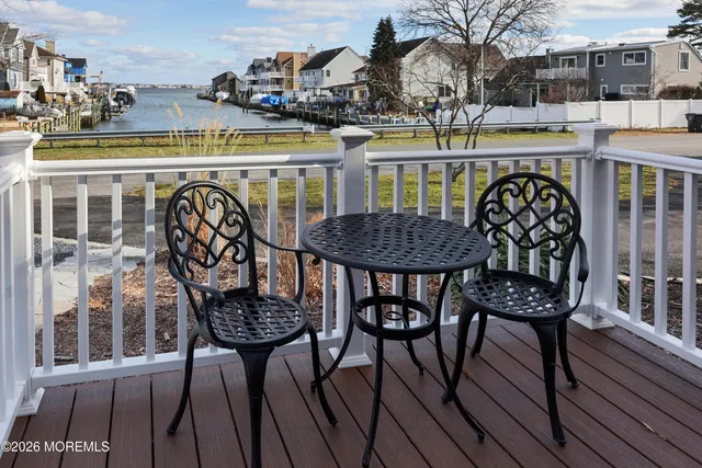 a bedroom with a bed and dresser next to a window
