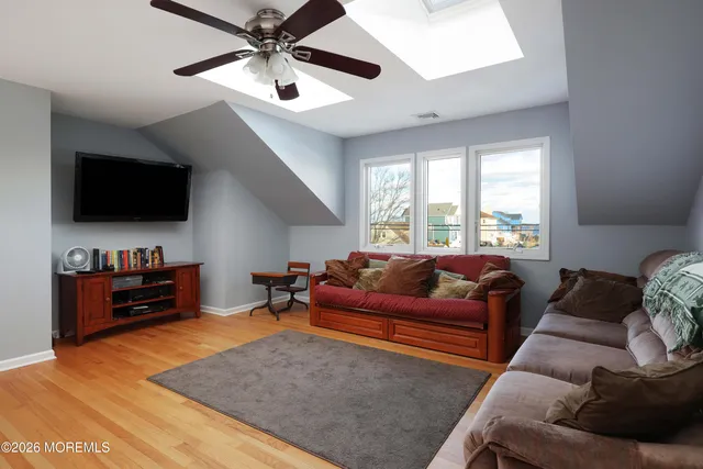 a view of a roof deck with chair and wooden floor