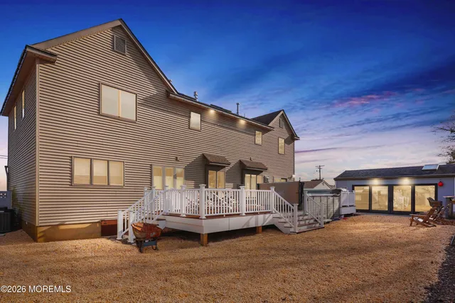 a living room with furniture a ceiling fan and a flat screen tv