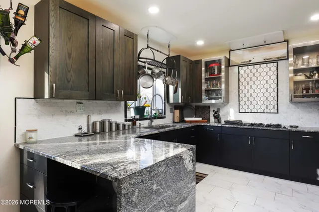 a spacious bedroom with a bed a couch and dresser