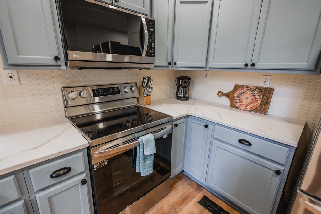 2 Watson Gap Road Mineral Bluff, GA 30559 - Photo 26 of 80 a kitchen with stainless steel appliances white cabinets and a stove a oven