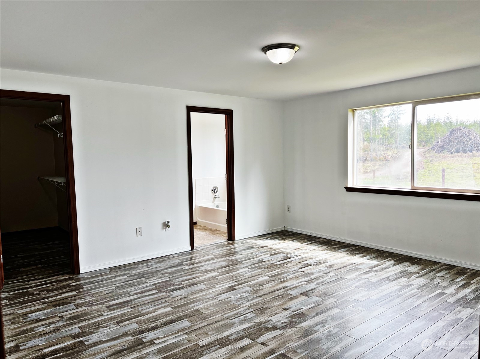 742 East Thornton Road Shelton, WA 98584 - Photo 11 of 39 a view of an empty room with wooden floor and a window