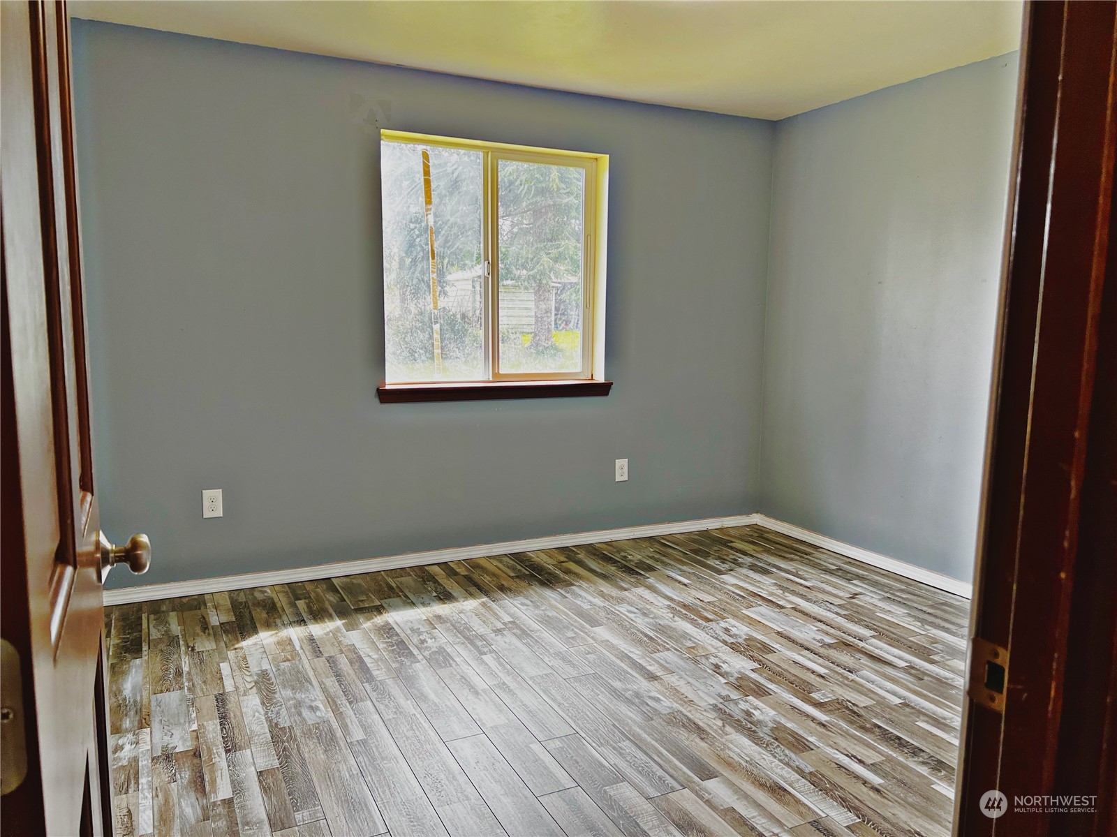 742 East Thornton Road Shelton, WA 98584 - Photo 20 of 39 a view of an empty room with wooden floor and a window