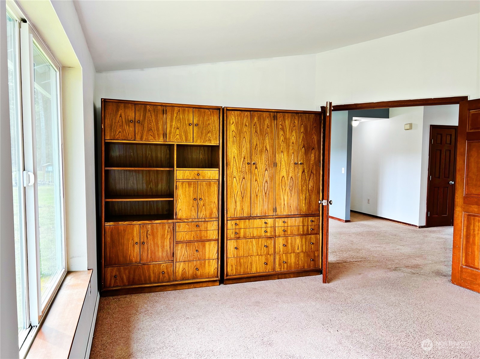 742 East Thornton Road Shelton, WA 98584 - Photo 22 of 39 an empty room with sliding door and wooden floor