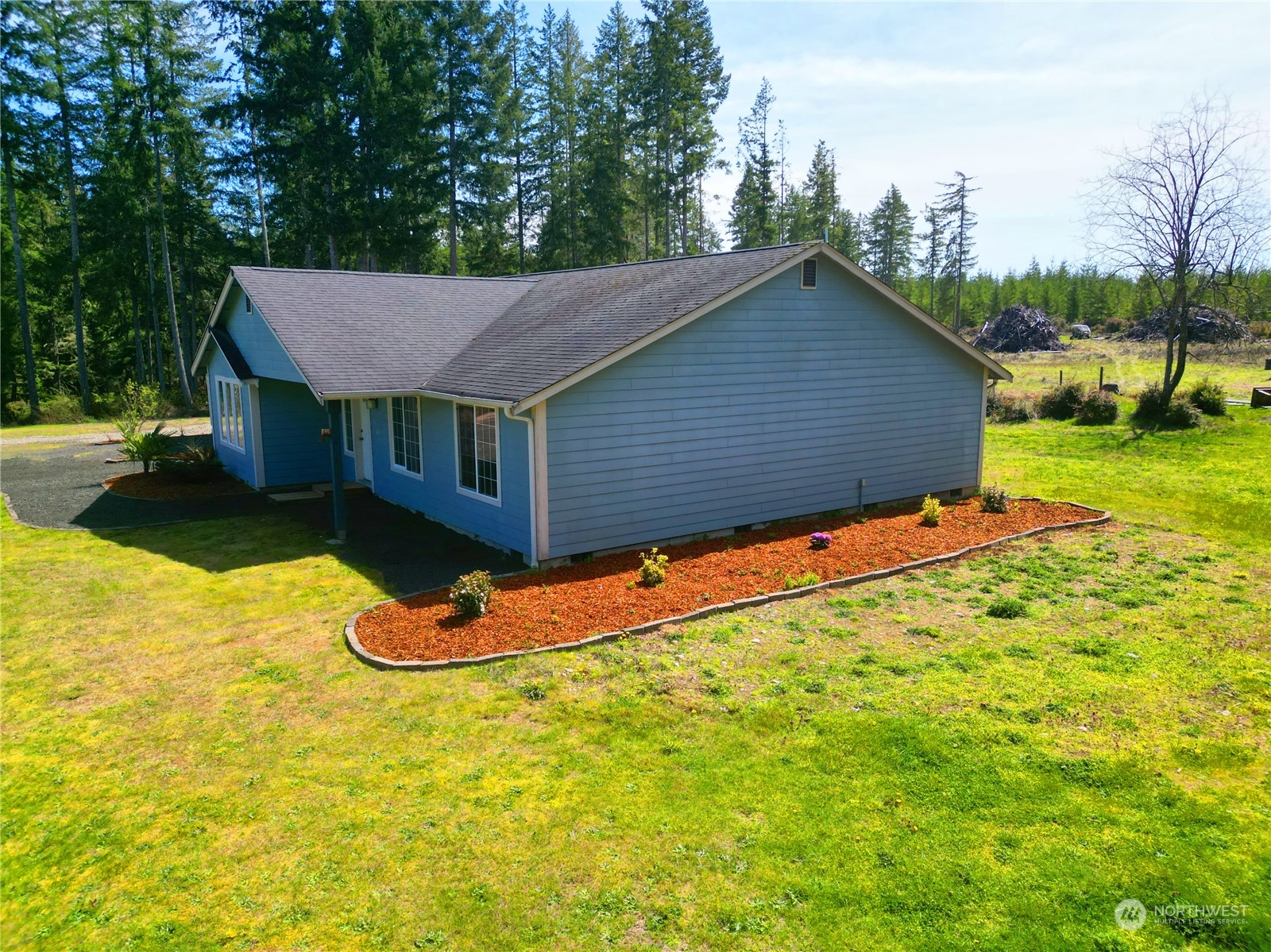 742 East Thornton Road Shelton, WA 98584 - Photo 5 of 39 a backyard of a house with wooden fence