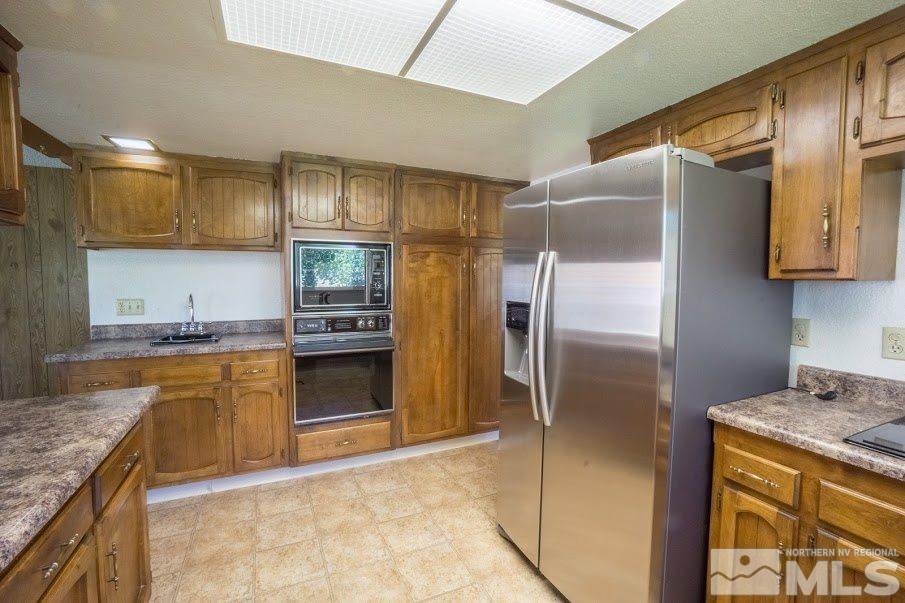 14045 Chamy Drive Reno, NV 89521 - Photo 10 of 25 a kitchen with granite countertop stainless steel appliances and counter space