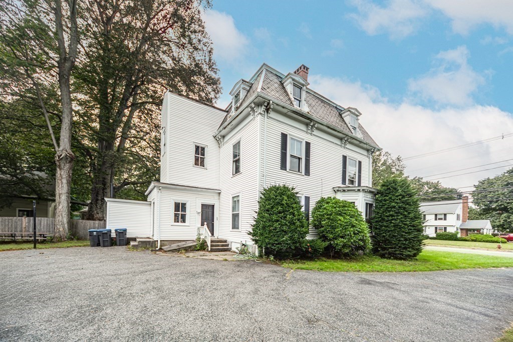 78 West Central Street, Unit 2 Natick, MA 01760 - Photo 2 of 12 a view of a white house next to a yard and road