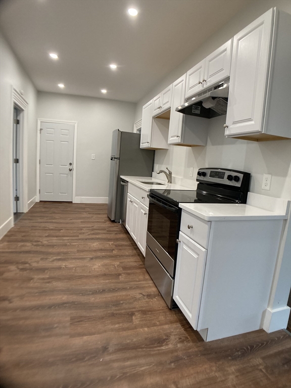 78 West Central Street, Unit 2 Natick, MA 01760 - Photo 4 of 12 a kitchen with stainless steel appliances granite countertop a stove a sink and a refrigerator
