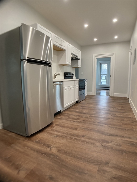 78 West Central Street, Unit 2 Natick, MA 01760 - Photo 5 of 12 a kitchen with stainless steel appliances a refrigerator and a stove top oven