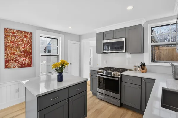 a kitchen with a sink a stove and cabinets