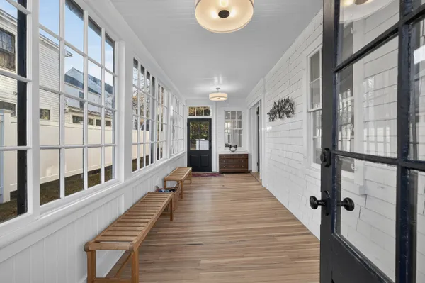 a view of a balcony with wooden floor and windows