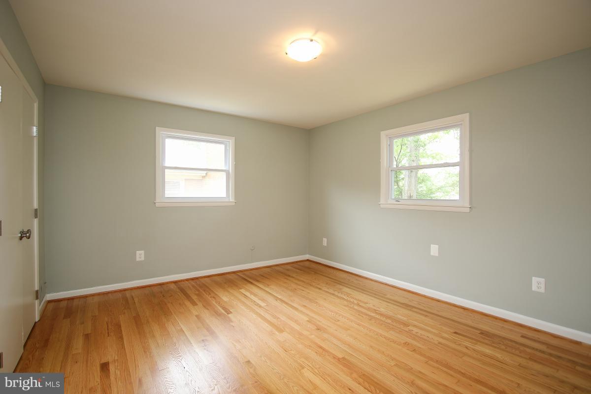 6903 Presley Road Lanham, MD 20706 - Photo 16 of 28 a view of empty room with wooden floor and fan