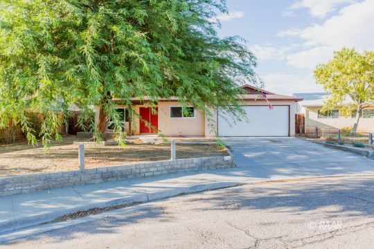 712 West Wilson Avenue Ridgecrest, CA 93555 - Photo 1 of 18 a view of house with backyard and tree