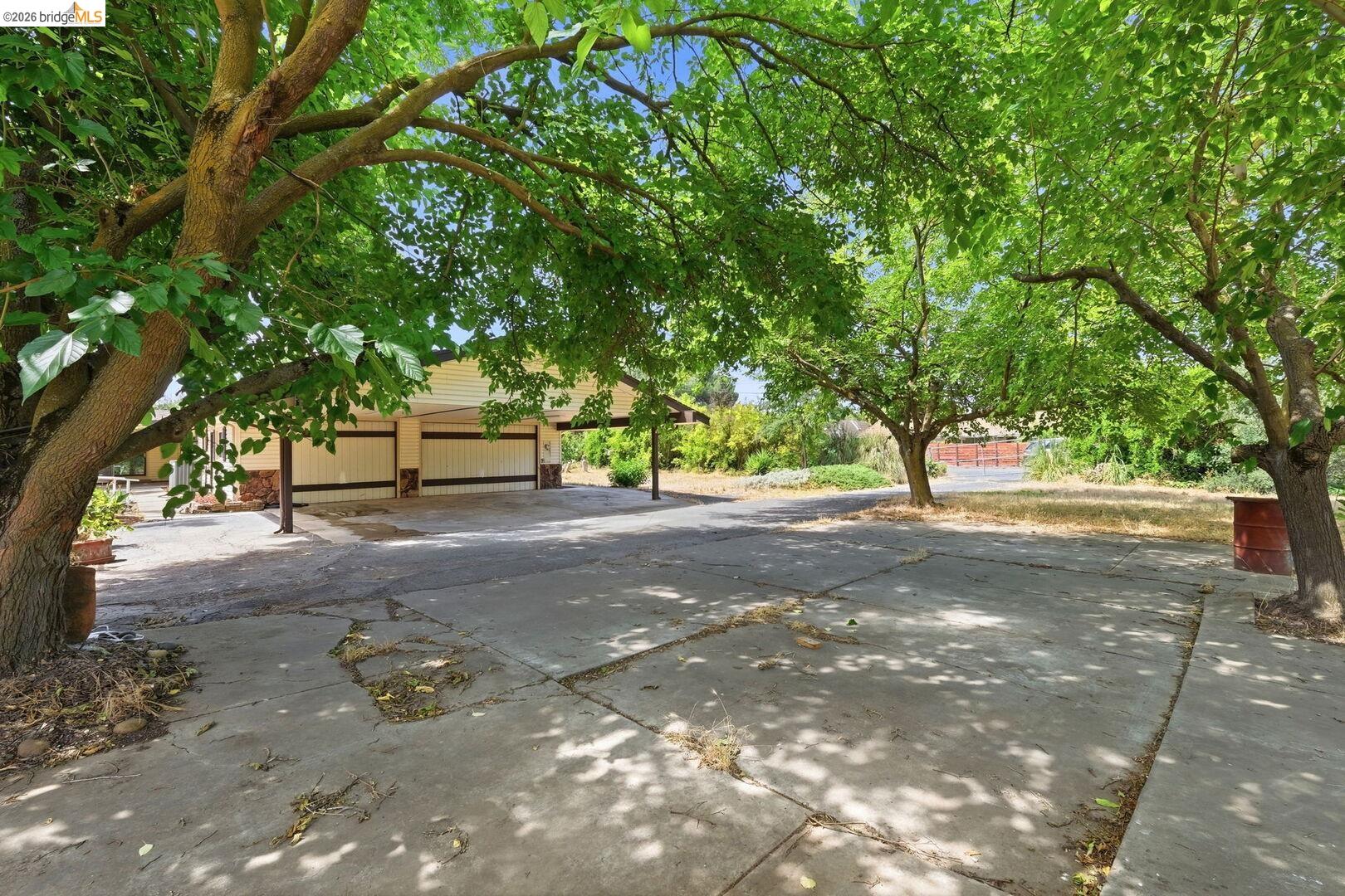 1590 Sunset Road Brentwood, CA 94513 - Photo 37 of 45 Spacious concrete driveway featuring mature trees providing natural shade