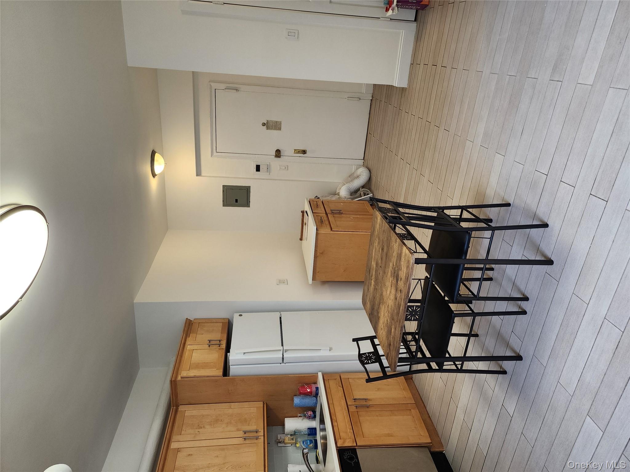 30-47 Hobart Street, Unit DDB Queens, NY 11377 - Photo 12 of 25 a view of a dining room with furniture and wooden floor