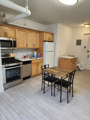 a kitchen with a table chairs stove and microwave