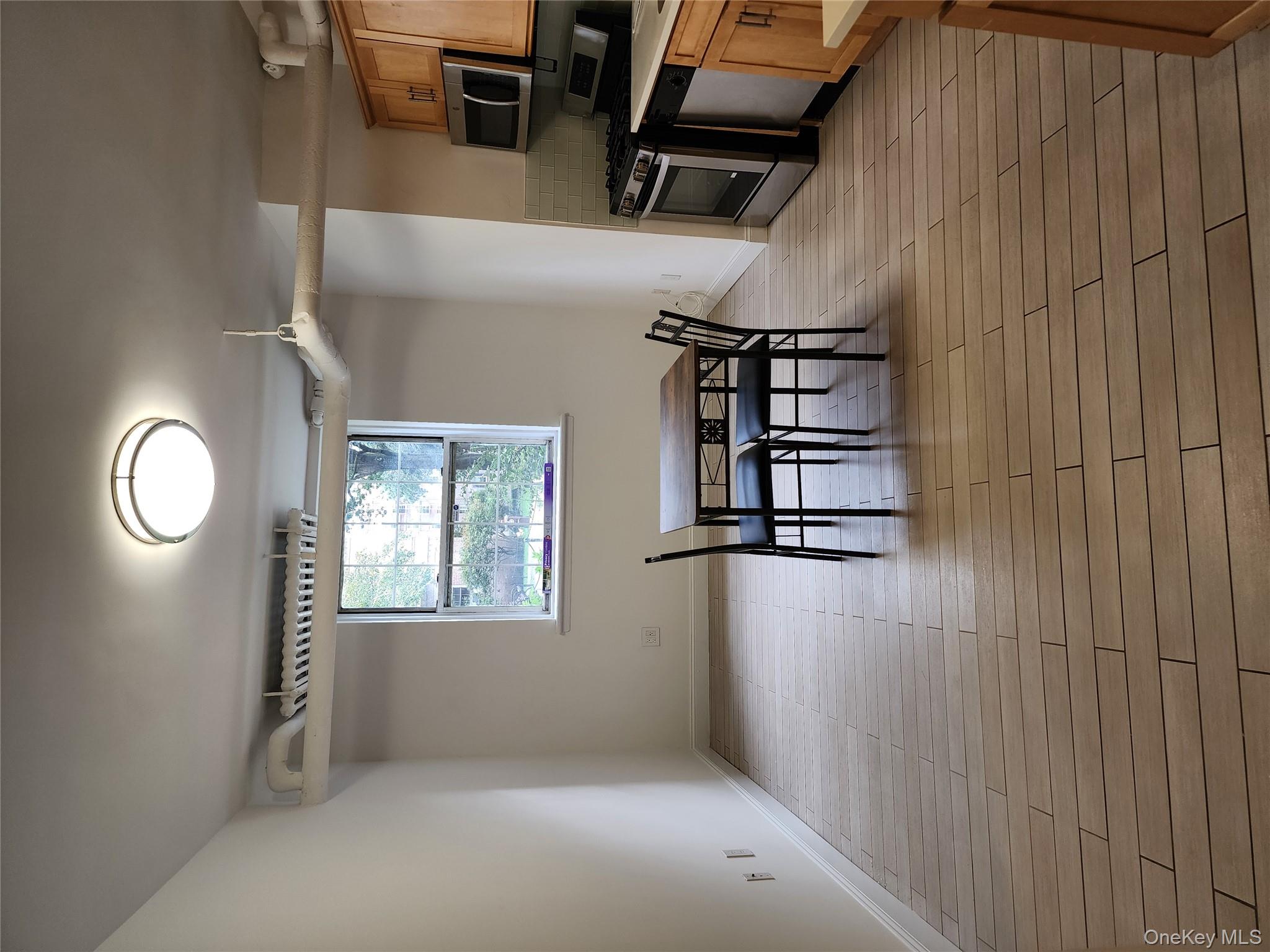 30-47 Hobart Street, Unit DDB Queens, NY 11377 - Photo 14 of 25 a view of a room with kitchen wooden floor and windows