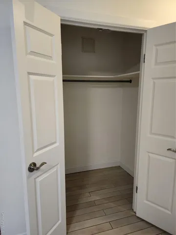 a view of a room with wooden floor