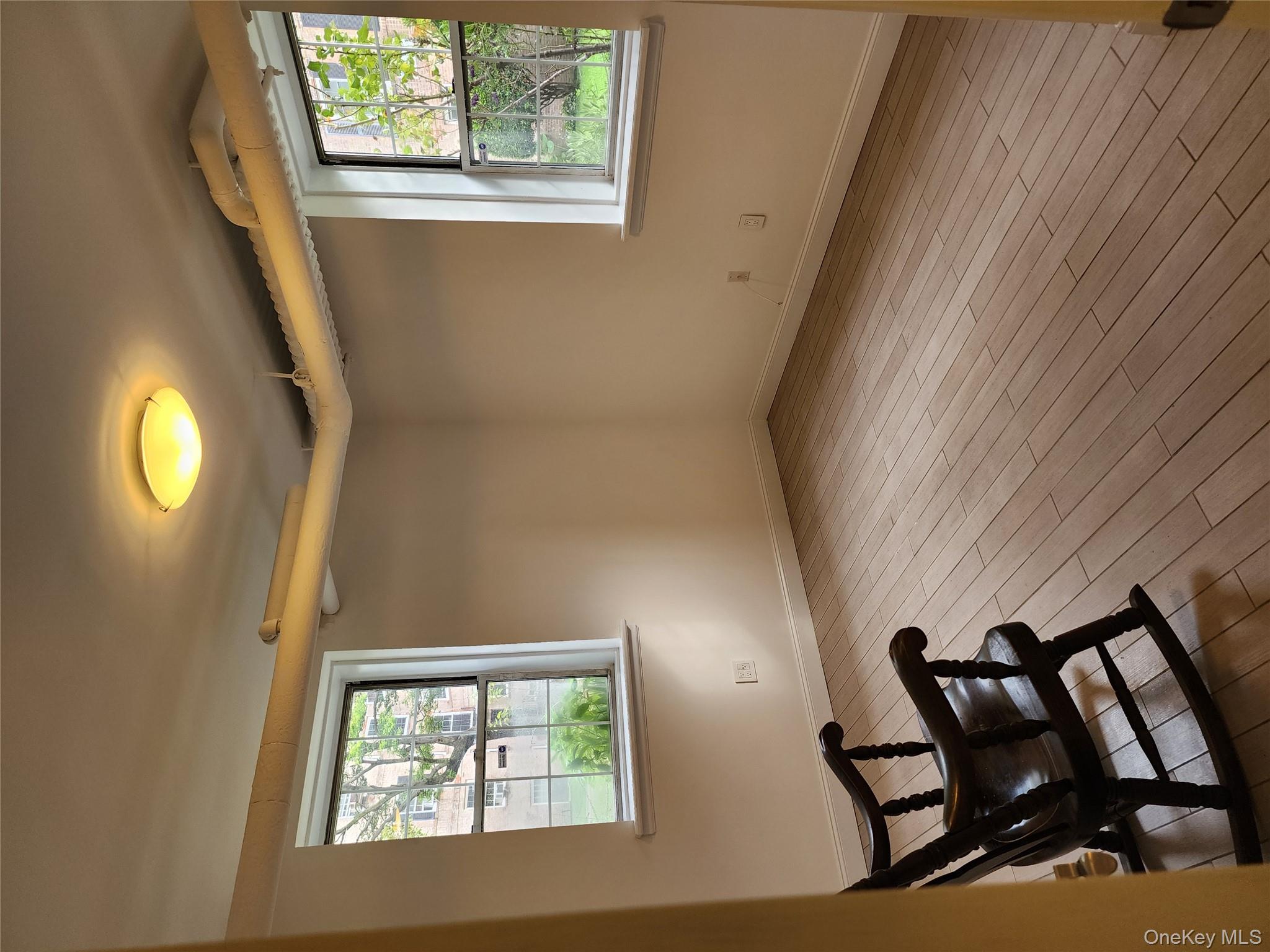30-47 Hobart Street, Unit DDB Queens, NY 11377 - Photo 21 of 25 a view of a room with wooden floor and a window
