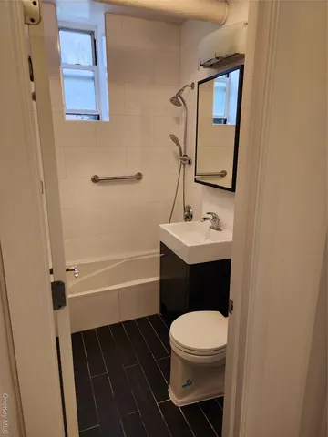 a bathroom with a toilet a sink and bathtub