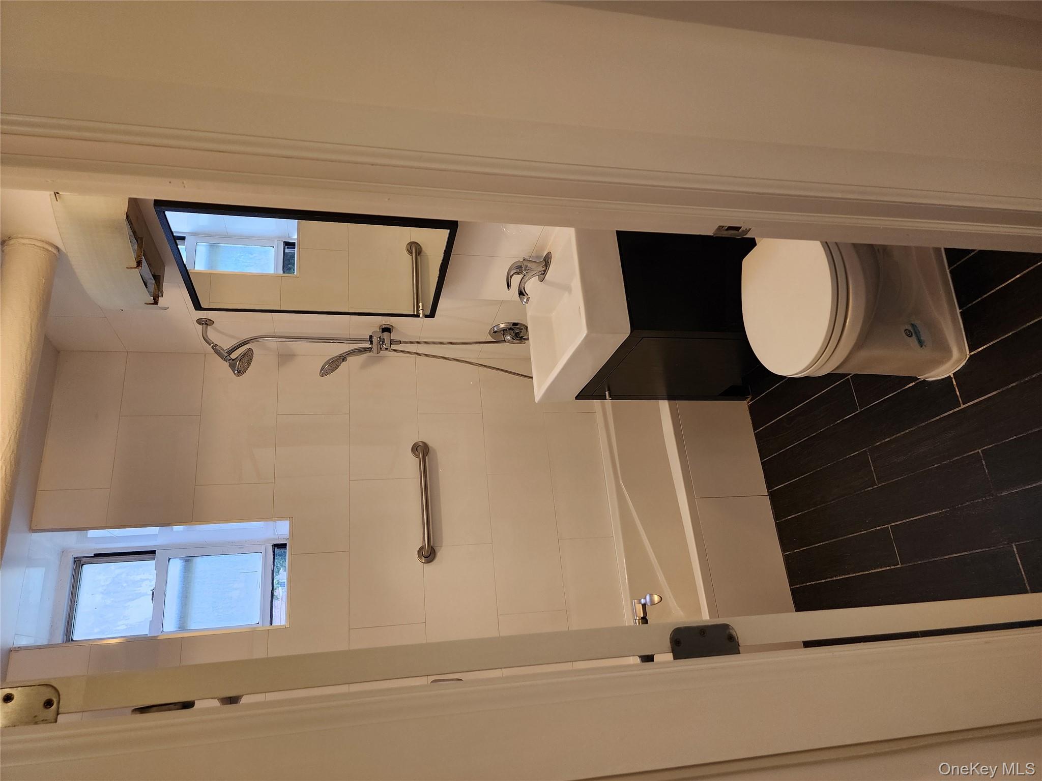 30-47 Hobart Street, Unit DDB Queens, NY 11377 - Photo 25 of 25 a bathroom with a toilet a sink and bathtub