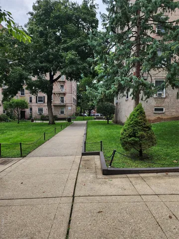 a front view of a house with a yard and a garage