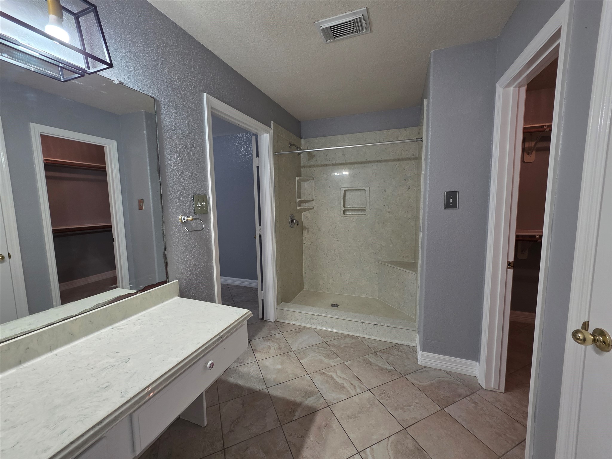 5614 Eagle Landing Houston, TX 77085 - Photo 11 of 28 a bathroom with a granite countertop sink a shower and a mirror