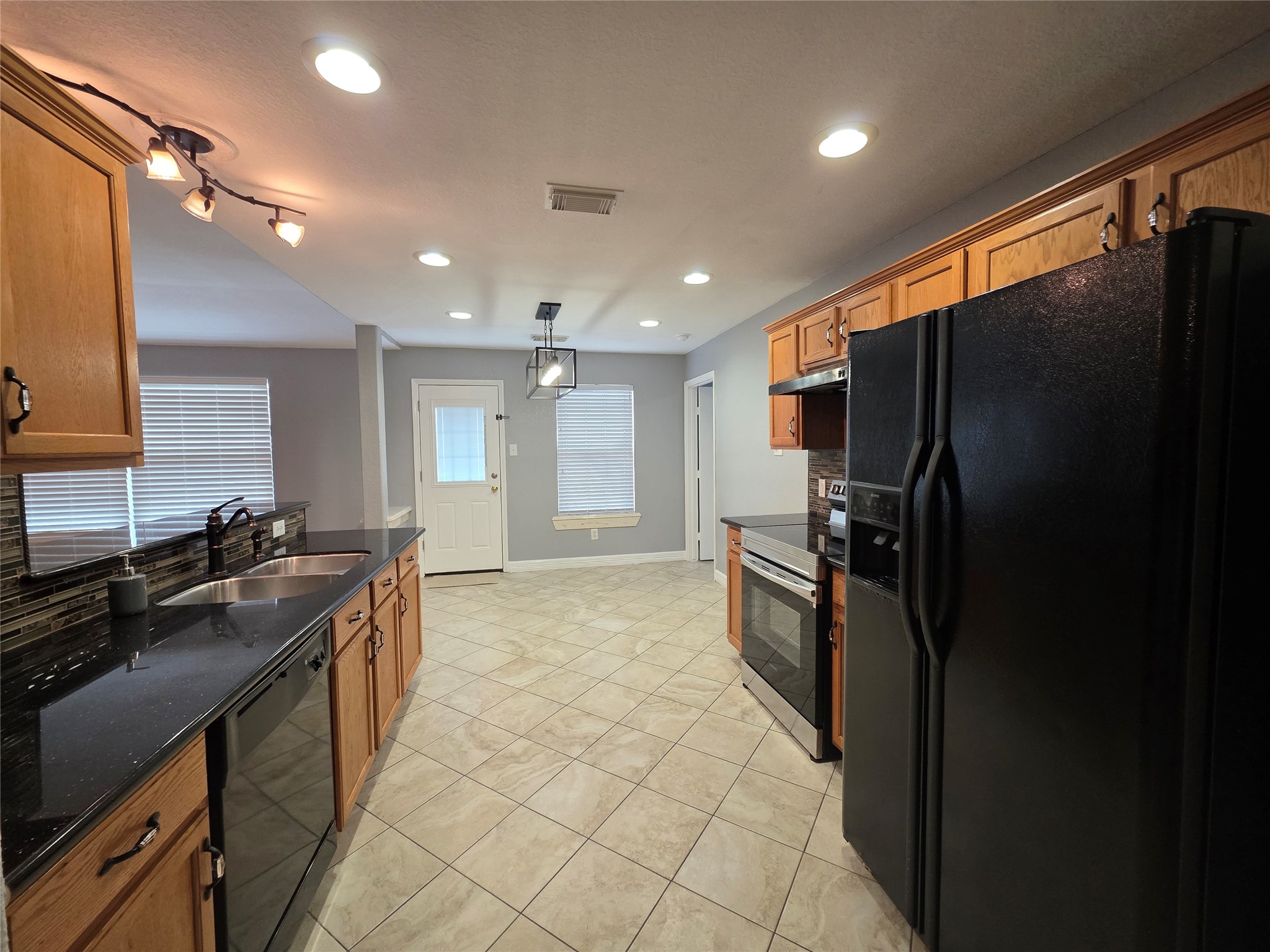 5614 Eagle Landing Houston, TX 77085 - Photo 7 of 28 a kitchen with stainless steel appliances granite countertop a refrigerator and a sink