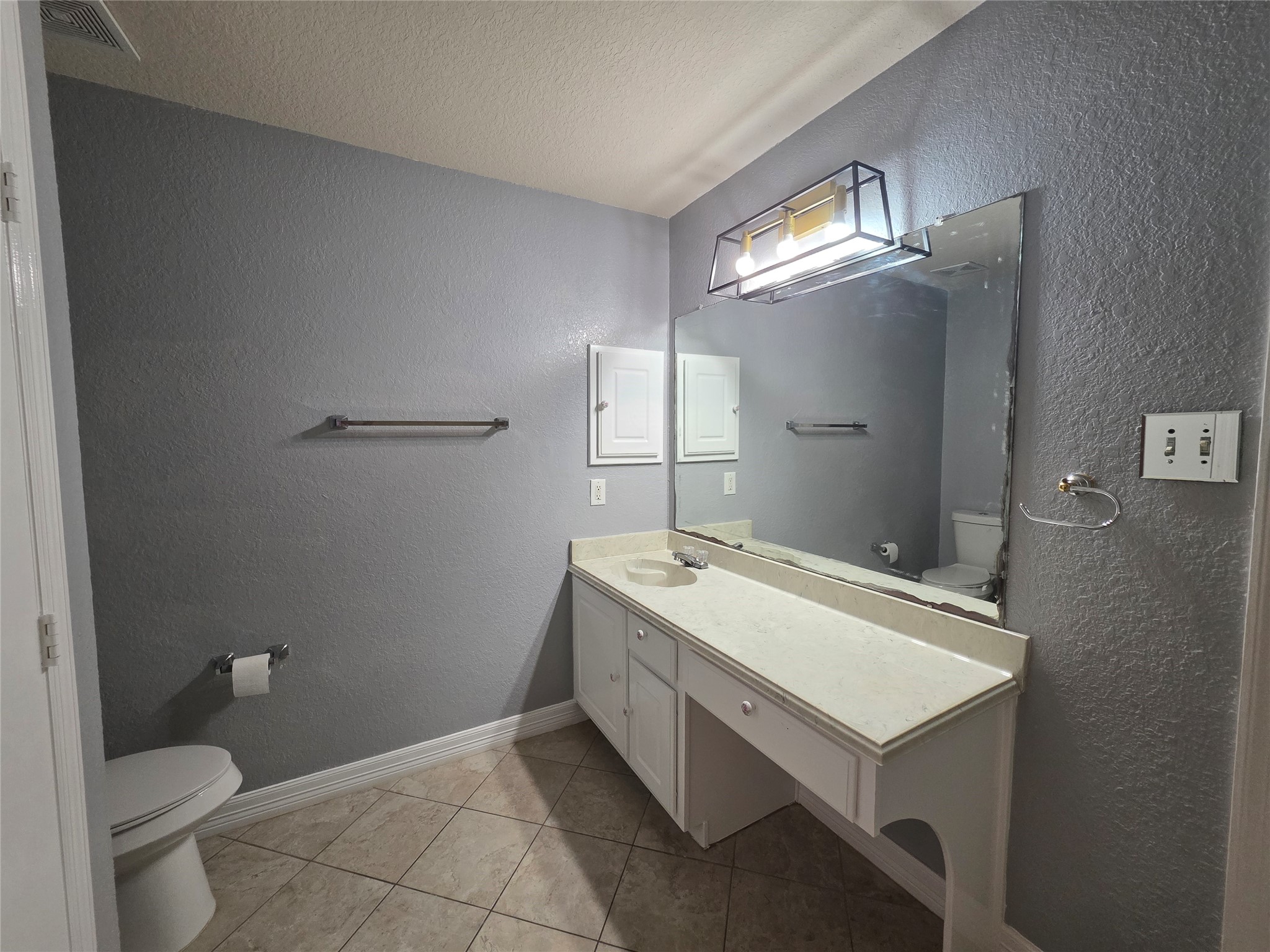 5614 Eagle Landing Houston, TX 77085 - Photo 10 of 28 a bathroom with a sink a toilet and a mirror