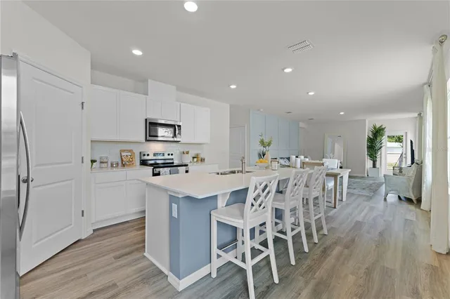 a kitchen with a microwave a stove and cabinets