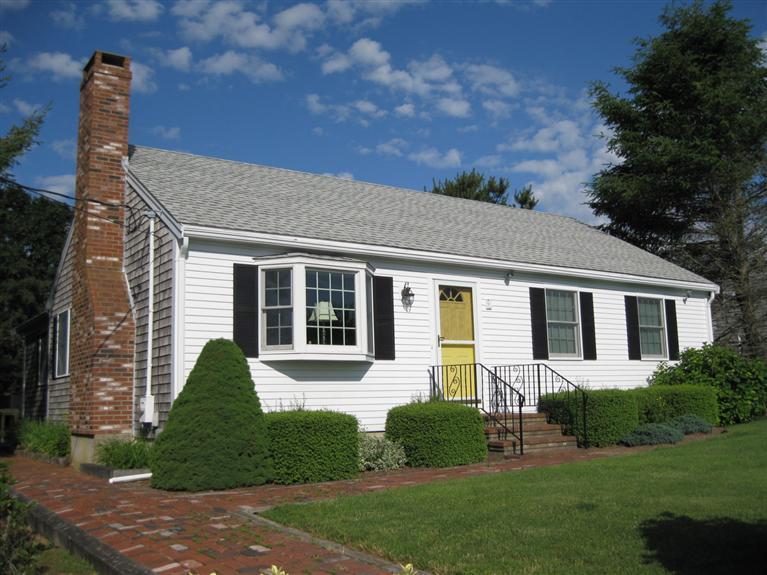 52 Clark Road Brewster, MA 02631 - Photo 1 of 32 a front view of a house with a yard and potted plants