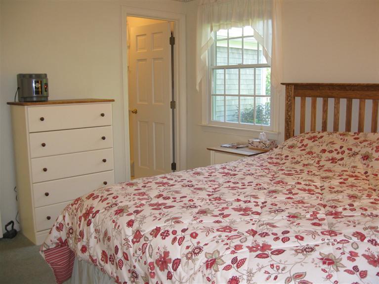 52 Clark Road Brewster, MA 02631 - Photo 14 of 32 a bedroom with a bed and a window