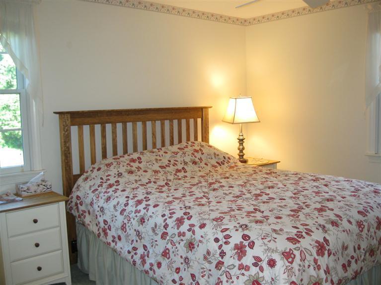 52 Clark Road Brewster, MA 02631 - Photo 15 of 32 a bedroom with a bed and a window